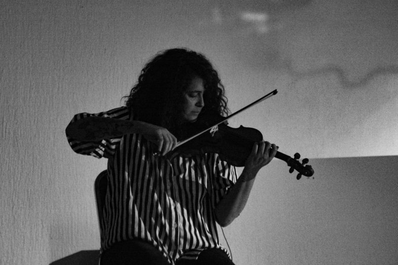 Photograph of a person playing the violin.