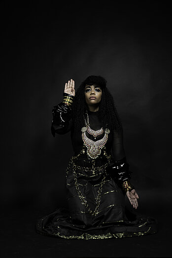 Photo of Devi Mambouka, aka Masma Dream World, wearing an elaborate dress and silver necklace.