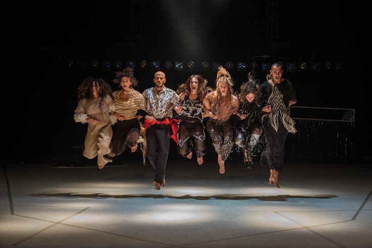 A group of people dance on stage.