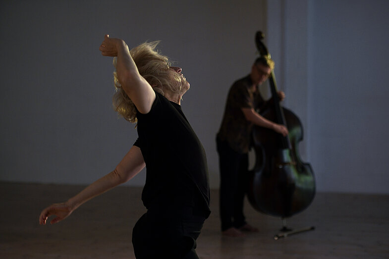 1.	A dancer in the foreground with a man playing a double bass in the background
