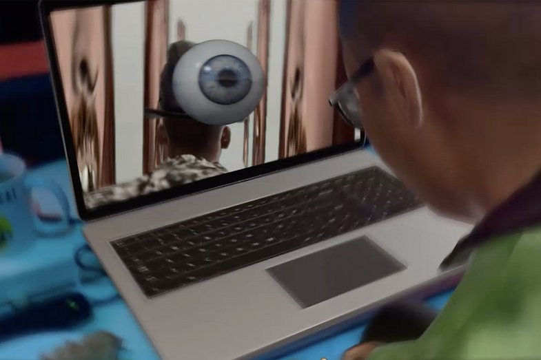 Rendering eines Avatars vor einem Laptop. Auf dem Bildschirm ist ein Augapfel zu sehen.