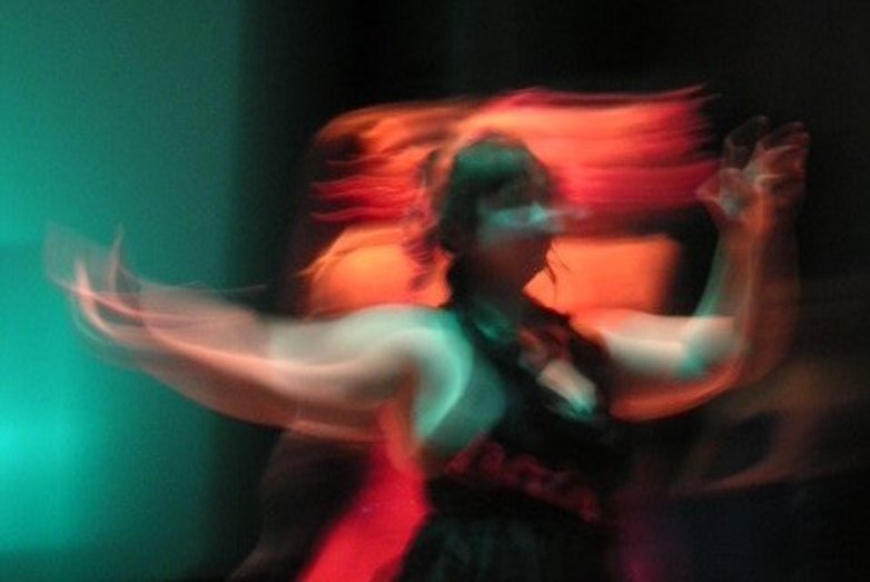A photograph of a person in motion. Long exposure technique was used.