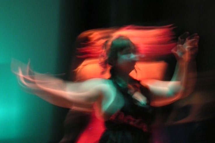 A photograph of a person in motion. Long exposure technique was used.